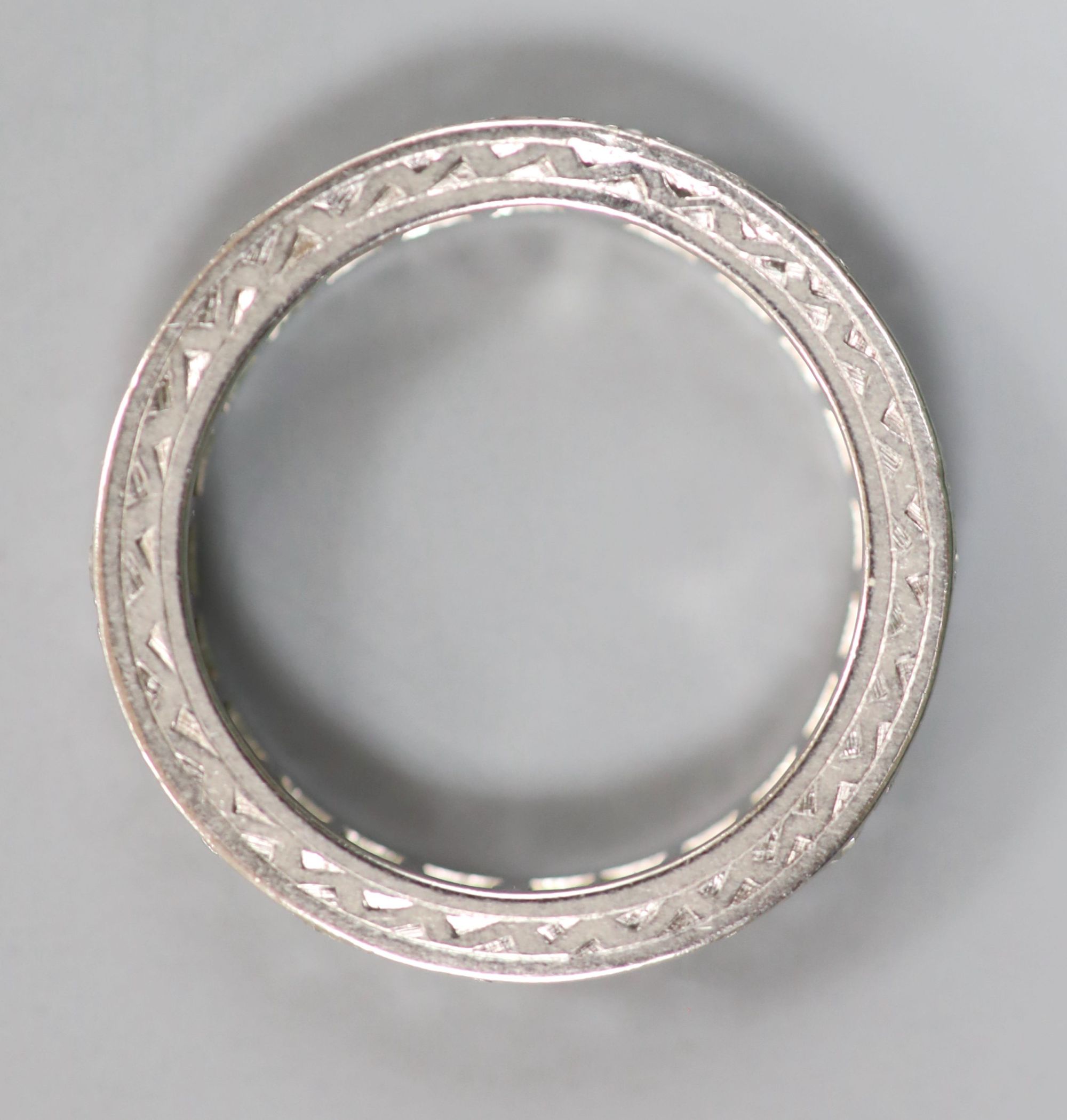 A white metal and diamond set full eternity ring, size K/L, gross 3.5 grams.